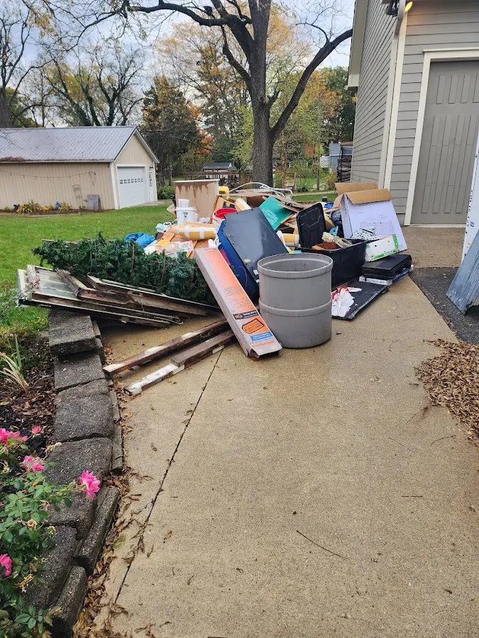 Dumpster being loaded with debris for Roofing Dumpster Rental in Fallowfield